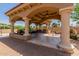 Covered patio with outdoor kitchen, dining area, and a grill at 6215 E Turquoise Ave, Paradise Valley, AZ 85253