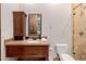 Bathroom with granite vanity, wood cabinets, and a tiled shower at 6215 E Turquoise Ave, Paradise Valley, AZ 85253