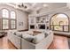 Spacious living room with hardwood floors, a large sectional sofa and a fireplace at 6215 E Turquoise Ave, Paradise Valley, AZ 85253