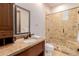 Spa-like bathroom with a walk-in shower and granite vanity at 6215 E Turquoise Ave, Paradise Valley, AZ 85253
