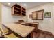 Basement wet bar with granite countertop and cabinets at 6215 E Turquoise Ave, Paradise Valley, AZ 85253