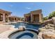 Luxury pool and spa with a rock waterfall at 6215 E Turquoise Ave, Paradise Valley, AZ 85253