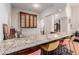 Modern wet bar with granite countertop, custom cabinetry, and bar stools at 6215 E Turquoise Ave, Paradise Valley, AZ 85253