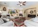 Spacious living room with fireplace, large TV, and comfortable seating at 20371 E Calle De Flores --, Queen Creek, AZ 85142