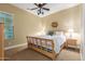 Bright bedroom with a wooden bed frame and tropical decor at 20371 E Calle De Flores --, Queen Creek, AZ 85142
