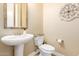 Powder room with pedestal sink, toilet, and decorative mirror at 20371 E Calle De Flores --, Queen Creek, AZ 85142