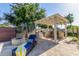 Outdoor kitchen and seating area under a pergola, adjacent to a fire pit at 20371 E Calle De Flores --, Queen Creek, AZ 85142