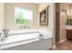 Relaxing bathroom with soaking tub and window at 20371 E Calle De Flores --, Queen Creek, AZ 85142