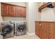 Laundry room with washer, dryer, and upper cabinets at 20371 E Calle De Flores --, Queen Creek, AZ 85142