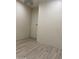 Spacious bedroom with wood-look floors and neutral walls at 2303 W Marshall Ave, Phoenix, AZ 85015