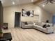 Spacious living room with L-shaped sectional sofa and wood-look flooring at 2303 W Marshall Ave, Phoenix, AZ 85015