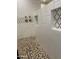 Modern shower with patterned tile and pebble floor at 2303 W Marshall Ave, Phoenix, AZ 85015