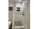 Walk in shower with pebble floor and patterned tile at 2303 W Marshall Ave, Phoenix, AZ 85015
