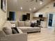 Open floor plan with gray sectional sofa and updated kitchen at 2303 W Marshall Ave, Phoenix, AZ 85015