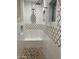 Elegant bathroom with a walk-in shower, patterned tile, and built-in seat at 2303 W Marshall Ave, Phoenix, AZ 85015