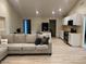 Open concept living area with a sectional sofa and updated kitchen at 2303 W Marshall Ave, Phoenix, AZ 85015