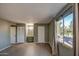 Well-lit bedroom with tile flooring and access to bathroom at 4443 W Solano S Dr, Glendale, AZ 85301