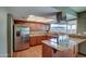 Updated kitchen with granite countertops, stainless steel appliances, and wood cabinets at 4443 W Solano S Dr, Glendale, AZ 85301