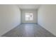 Spacious bedroom with gray tile floors and large window at 16355 W Desert Mirage Dr, Surprise, AZ 85388