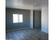 Spacious bedroom with gray walls and wood-look flooring at 2121 N Center Sts # 151, Mesa, AZ 85201