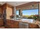 Kitchen features granite countertops, stainless steel appliances, and a window overlooking scenic views at 41915 N 111Th Pl, Scottsdale, AZ 85262