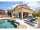 Luxury backyard with a large pool, patio furniture, and home at 16612 N 151St Ln, Surprise, AZ 85374