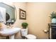 Clean bathroom with pedestal sink, toilet, and decorative accents at 16612 N 151St Ln, Surprise, AZ 85374