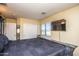 Comfortable bedroom with a large bed, TV, and window with blinds at 16612 N 151St Ln, Surprise, AZ 85374