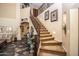 Elegant staircase with wrought iron railing leading to upper level at 16612 N 151St Ln, Surprise, AZ 85374