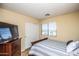 Cozy bedroom with a double bed, dresser, and large window at 16612 N 151St Ln, Surprise, AZ 85374