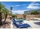 Peaceful poolside setting with lounge chairs and landscaping at 16612 N 151St Ln, Surprise, AZ 85374