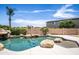 Serene pool with rock features and spacious patio at 16612 N 151St Ln, Surprise, AZ 85374