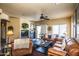 Cozy living room with leather furniture, fireplace, and lots of natural light at 16612 N 151St Ln, Surprise, AZ 85374