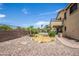 Landscaped backyard with a pathway and a view of the home at 16612 N 151St Ln, Surprise, AZ 85374