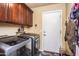 Laundry room with washer, dryer, cabinets, and extra storage at 16612 N 151St Ln, Surprise, AZ 85374