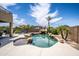 Relaxing backyard oasis featuring a freeform pool and patio furniture at 16612 N 151St Ln, Surprise, AZ 85374