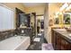 Modern bathroom with a soaking tub, walk-in shower and double sinks at 16612 N 151St Ln, Surprise, AZ 85374