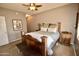 Spacious bedroom with wooden furniture and a ceiling fan at 20100 N 78Th Pl # 3090, Scottsdale, AZ 85255