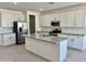 Modern kitchen with white cabinets, gray countertops, and island at 5612 W Paseo Way, Laveen, AZ 85339