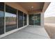 Covered patio with sliding glass doors and views of the desert landscape at 10010 S 37Th Ave, Laveen, AZ 85339