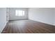 Well-lit bedroom with wood-like tile floors and large window at 10010 S 37Th Ave, Laveen, AZ 85339