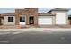 Modern home exterior with stone and stucco accents; two-car garage at 10010 S 37Th Ave, Laveen, AZ 85339