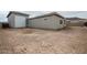 Rear view of the house showcasing a large garage and desert landscaping at 10010 S 37Th Ave, Laveen, AZ 85339