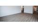 Spacious bedroom with wood-look tile floors and access to bathroom at 10010 S 37Th Ave, Laveen, AZ 85339