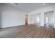 Open concept Gathering room with wood-look tile flooring and access to other rooms at 10010 S 37Th Ave, Laveen, AZ 85339