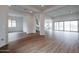 Open living space with wood-look floors and views into kitchen and backyard at 10010 S 37Th Ave, Laveen, AZ 85339