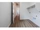 Laundry room with wood-look tile floors and built-in shelving at 10010 S 37Th Ave, Laveen, AZ 85339