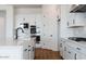 Modern kitchen with white cabinets, quartz countertops, and black faucet at 10010 S 37Th Ave, Laveen, AZ 85339