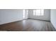 Bright bedroom featuring wood-look floors and access to patio at 10010 S 37Th Ave, Laveen, AZ 85339