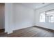 Spacious bedroom with wood-look floors and large window for natural light at 10010 S 37Th Ave, Laveen, AZ 85339